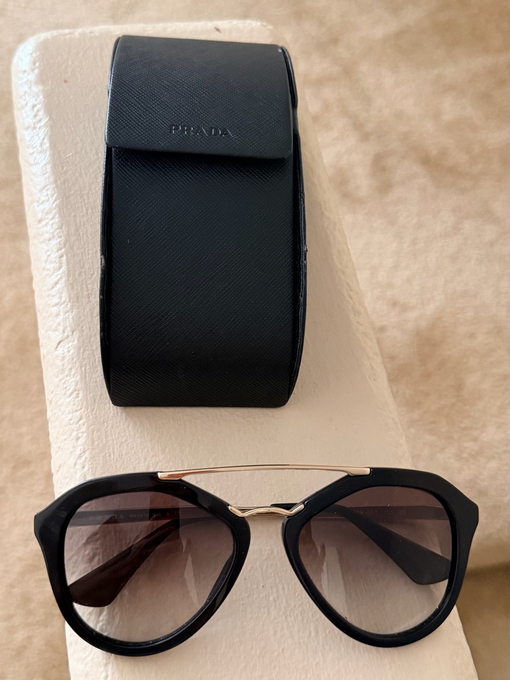 Prada Black Frame Sunglasses with Gold Bridge and Gradient Lenses